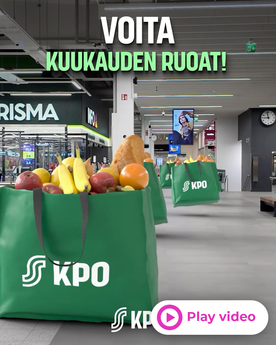 In-store promo: 'VOITA KUUKAUDEN RUOAT!' over large green KPO bags filled with fruit in a supermarket.