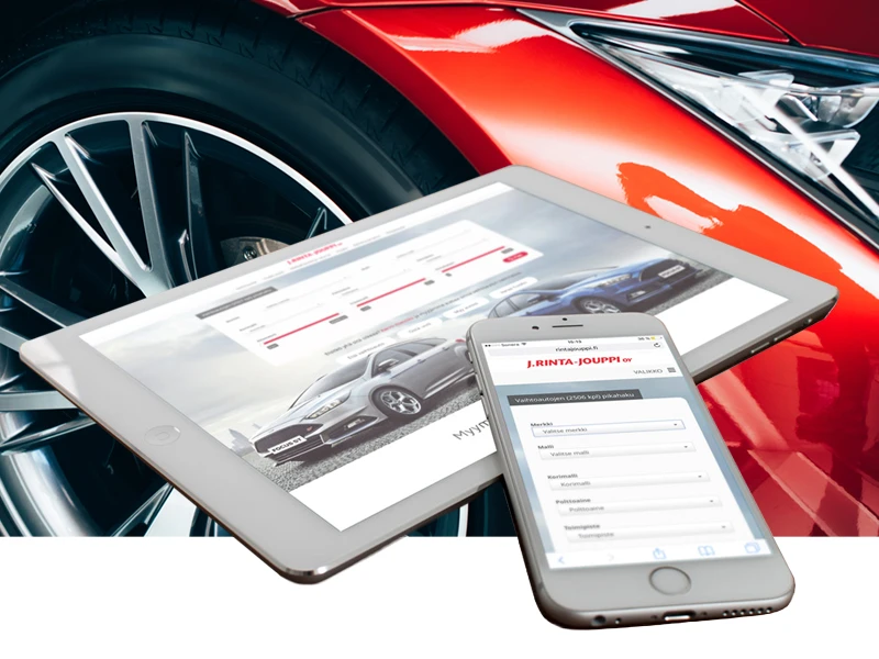 Red car with a smartphone and tablet displaying a car sales website nearby on the hood / dashboard area? But skip ambiguous. Try again for clarity.